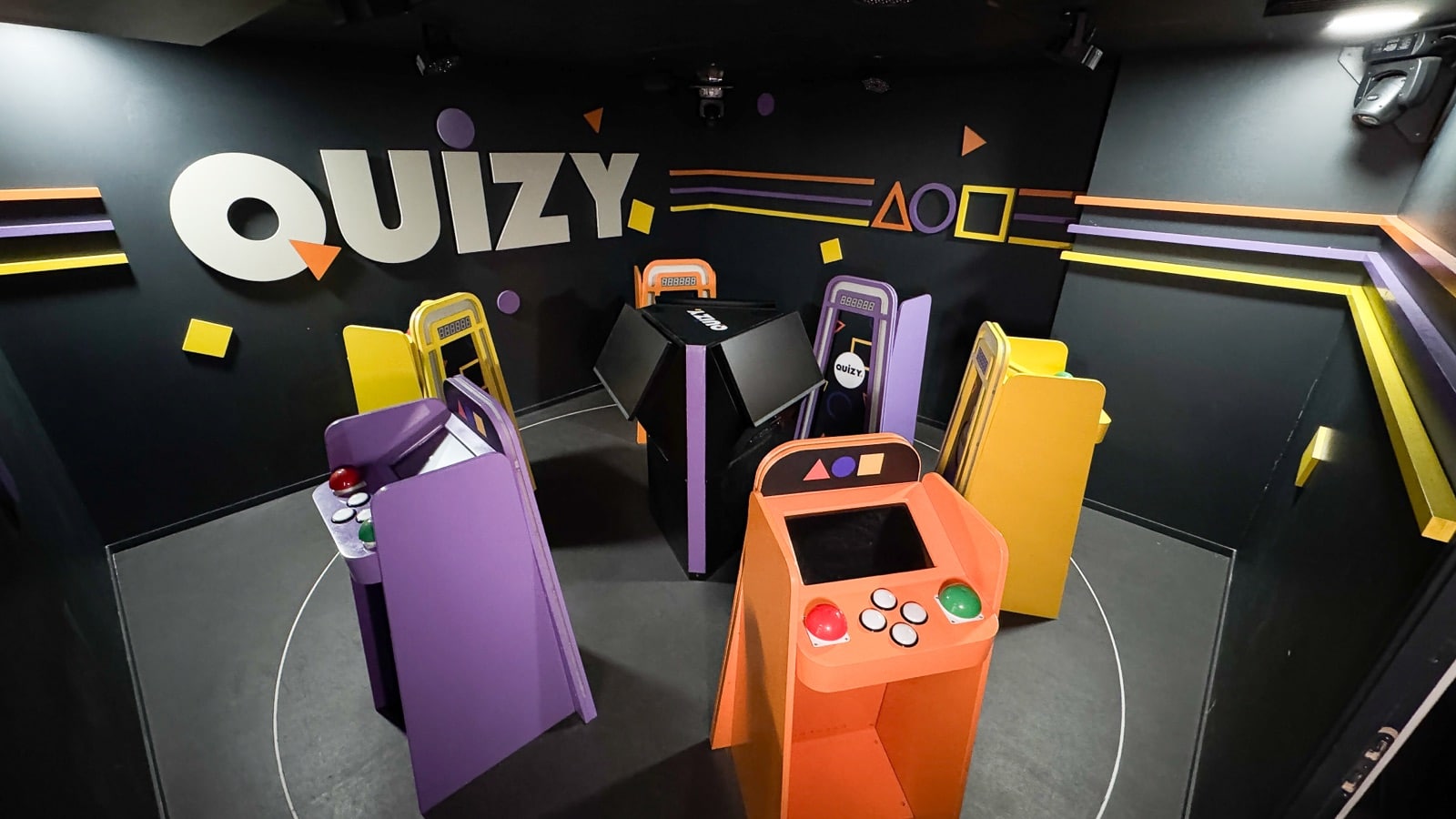 Quizy game show room with six player stations